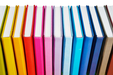 Books. A lot of books with bright covers in one pile isolated on white background. Design element, paper and leather texture. Colorful books on the shelf, close up     