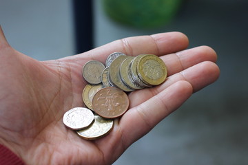 England Coins in the Tourist's Hand. Selective Focus