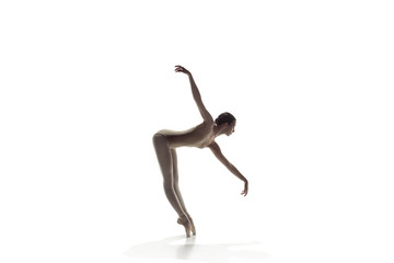 Young graceful female ballet dancer or classic ballerina dancing isolated on white studio....