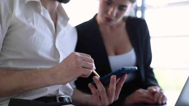 Business Office. Man With Phone And Woman Working At Computer