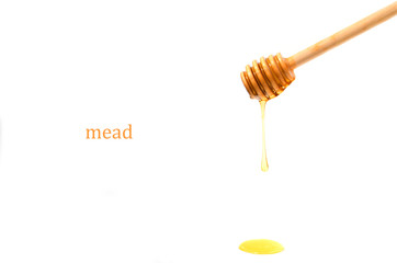 Spoon for honey on white background.Honey flows down from wooden spoon.