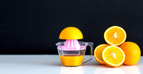 Orange juice and orange on the dark background.