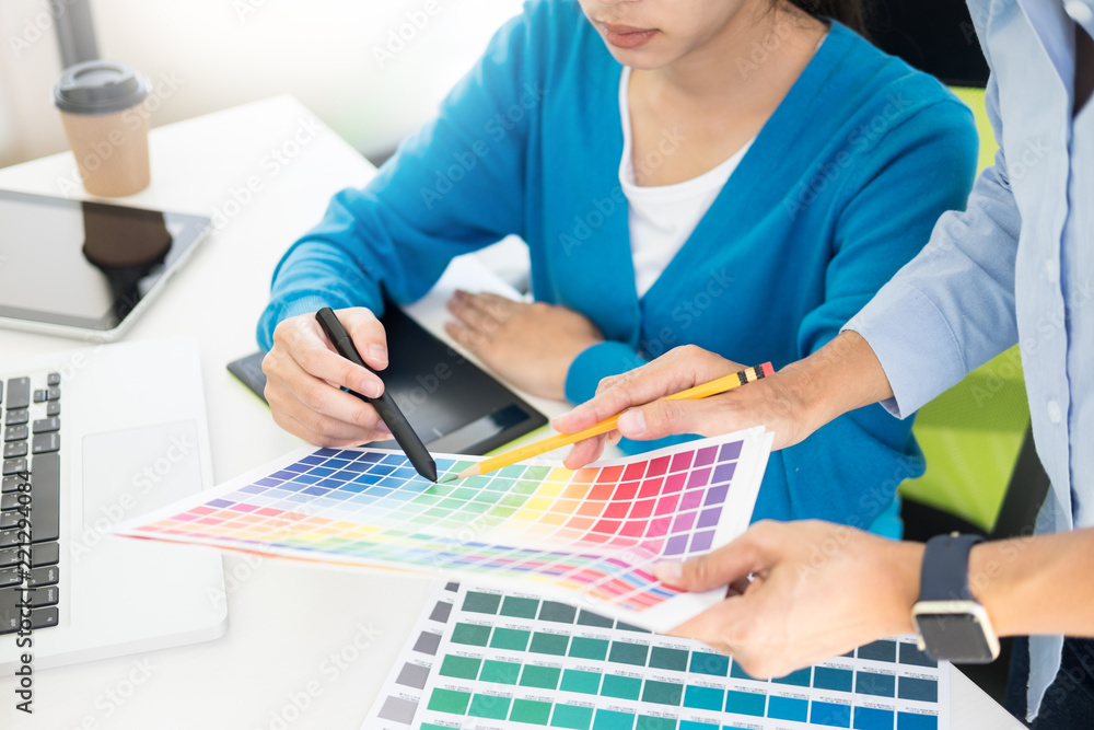 Poster creative or interior designers teamwork with pantone swatch and building plans on office desk, archi