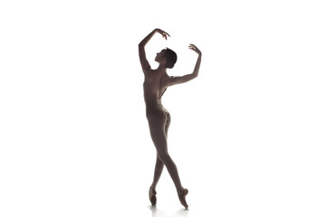 Young graceful female ballet dancer or classic ballerina dancing isolated on white studio. Caucasian model on pointe shoes