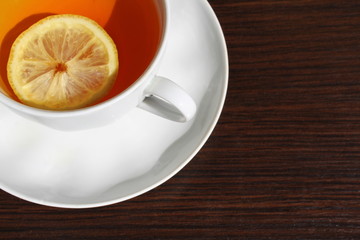 A cup of tea with a slice of lemon