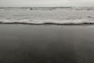 A close view of the sea undertow in the Almaciga black sand beach, in Tenerife, Canary