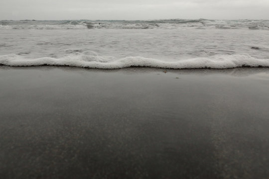 A close view of the sea undertow in the Almaciga black sand beach, in Tenerife, Canary
