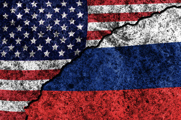 two flags of the USA and Russia on a cracked concrete wall