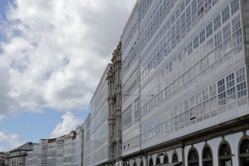 Typical Galician galerias, white enclosed balconies made of wood and glass, in the capital city La Coru&ntilde;a