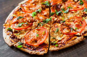 Pizza with Mozzarella cheese, Tomatoes, pepper, Spices and Fresh Basil. Italian pizza. Pizza Margherita or Margarita. on wooden background