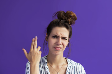 A dangerous daring woman, shows a gesture to the camera, folding her fingers in the form of a...
