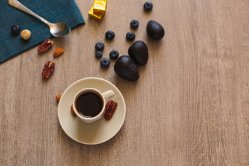 Cup of Coffee, Spoon and Fruit on a Wooden Table. Autumn Theme