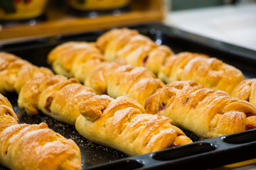 Buns from puff pastry stuffed with dark gooseberries