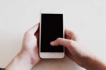 hand holding smart phone isolated on white