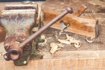 Carpenter old / retro tool's on a dusty table with sawdust.