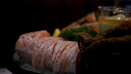 Raw salmon slice or salmon sashimi in Japanese style fresh serve on ice with fresh wasabi