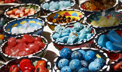Fototapeta na wymiar Different colored semiprecious stones in handmade plates