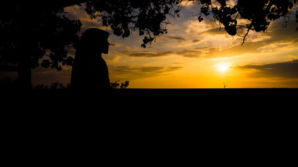 Silhouette of muslim women see beautiful sunset