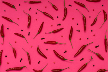 Very Hot Chili Peppers on Pink Paper Background Top View