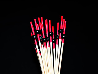 wooden sticks with black beads for food decoration. Skewers for the preparation of canapes. Props for Chinese food.