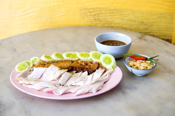 Fried pock and boiled chicken, fillet on a plate with a slice of cucumber to eat a meal with rice and sauce, Fast Food commonly eaten in the countries of Thailand