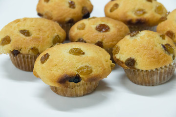  raisin muffin on a white background.