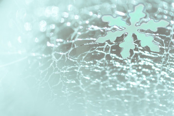 Christmas and New Year. Snowflake against the background of cracked ice. Christmas festive background