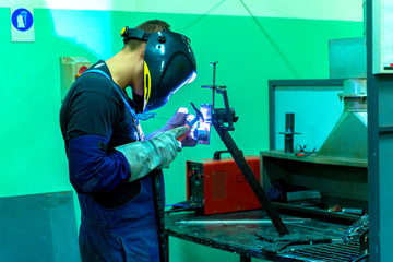 Welder in the workshop will weld the part