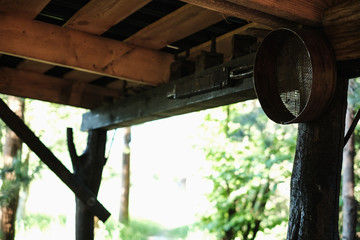 Antique utensils on wooden shelves.