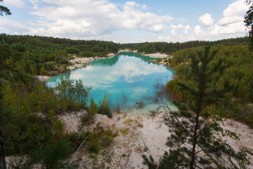 Fototapeta na wymiar blue pond in the pine forest, Kyshtym, Russia