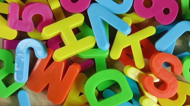 Plastic colored letters and numbers. Alphabet background. Top view