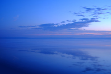 Beautiful sunset over sea with reflection in the water.