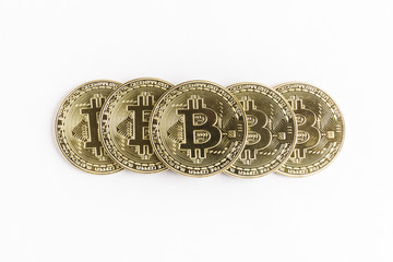 several bitcoin gold coins piled up in a pyramid shape on a white background
