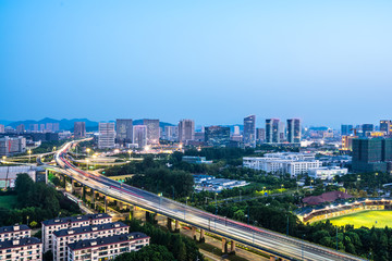 Fototapeta na wymiar busy traffic road with city skyline in hangzhou china