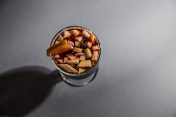 mulled wine, in a glass goblet on a gray background