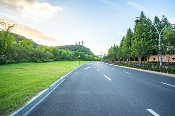 empty asphalt road with city skyline