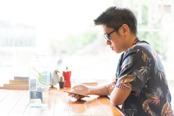 A hipster boy with sunglasses is drinking hot coffee.