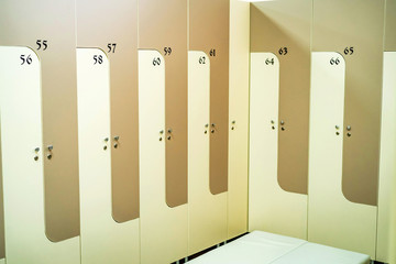 Wooden lockers in sports gym locker room