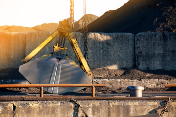 Coal Loading. Clamshell bucket in the cargo port.