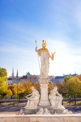 Fototapeta premium Picturesque autumn view on old town of Vienna from the historic building of the austrian parliament. Sculpture of Pallas Athene Fountain