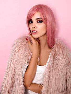 Young woman wearing pink fur coat