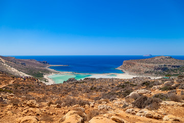 Balos lagoon (Balos beach) on Crete island. Tourists relax and bath in crystal clear water of Mediterranean Sea, Greece.