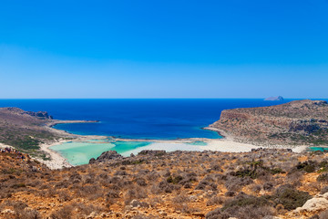 Fototapeta na wymiar Balos lagoon (Balos beach) on Crete island. Tourists relax and bath in crystal clear water of Mediterranean Sea, Greece.