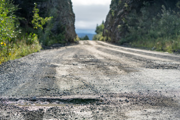 The McCarthy Road from Chitina to McCarthy in Wrangell-St. Elias National Park is dangerous, gravel road with potholes and railroad spikes that can flatten tires