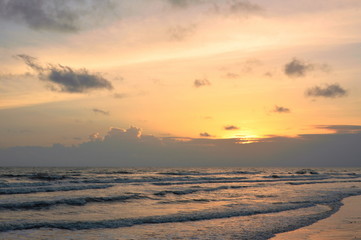 landscape of sea and water surf to beach in sunset