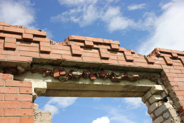 the remains of a ruined building after, an accident and a catastrophe, against a blue cloudy sky