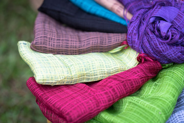 Fototapeta na wymiar Stack of colourful silk scarfs