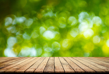 Old wood plank with abstract natural green blurred bokeh background for product display 