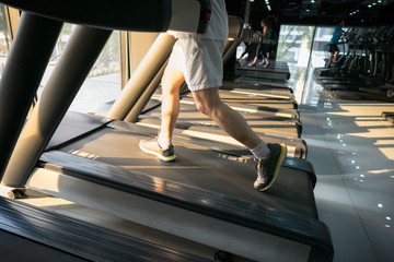 Machine treadmill with people running closeup at fitness gym