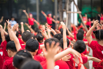 Fototapeta premium School children raising hands up